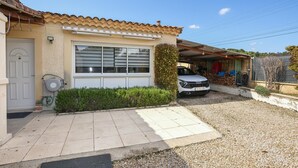 A residential house with a tiled roof, a garage, and a driveway. - Lovely home in Vaison-la-Romaine with house a panoramic view (Vaison-la-Romaine)