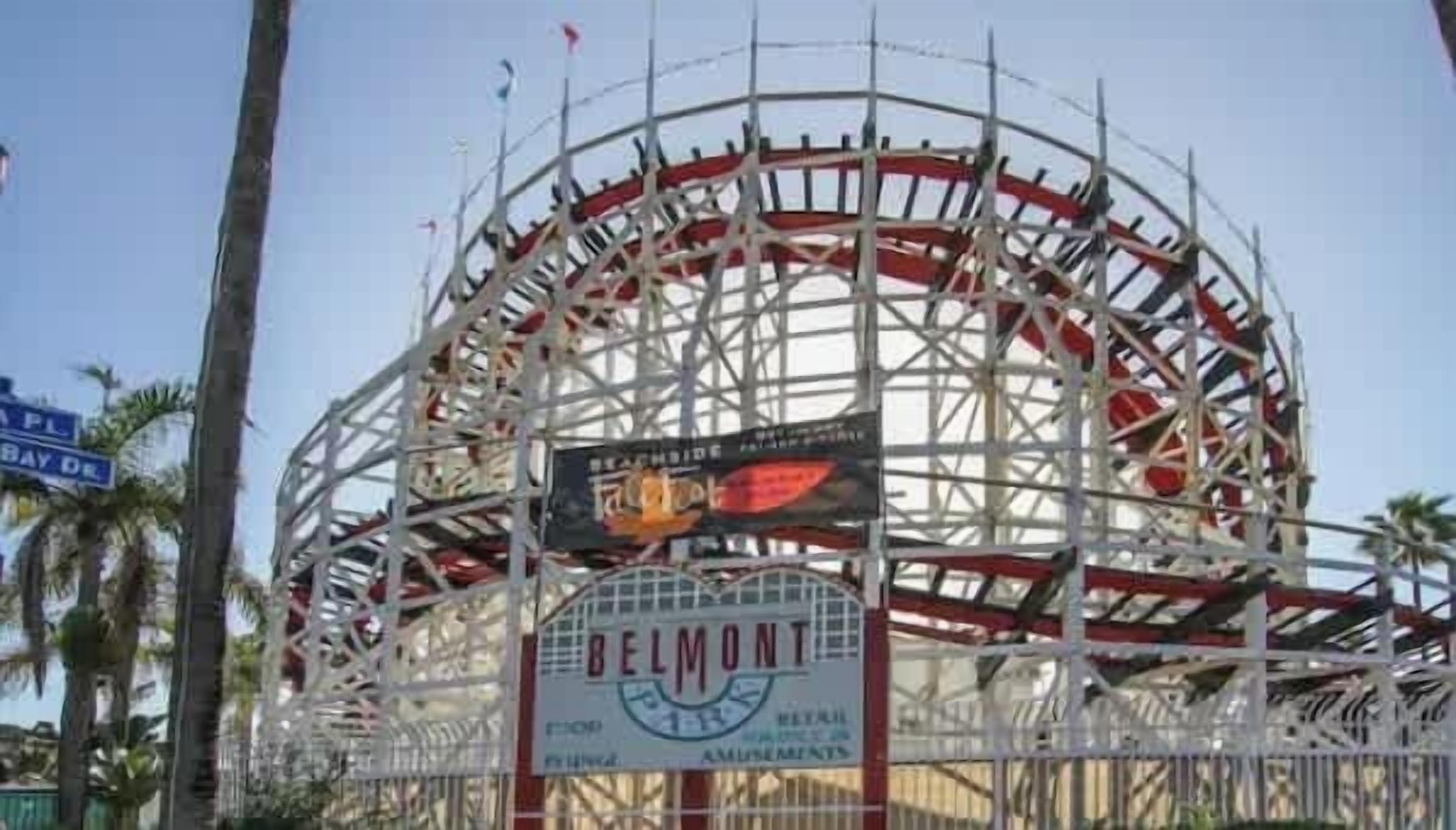 A roller coaster with a sign that reads "BELMONT" and "ELITE AMUSEMENTS".