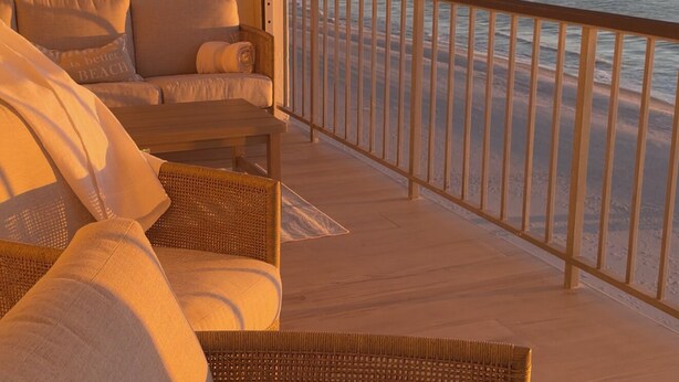 A balcony with wicker furniture and a view of the ocean. - 2-Bedroom Beachfront Condo on Private Beach Longboat Key (Longboat Key)
