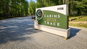 A sign for 'Cabins Off the Trace' with a cabin number 3158.