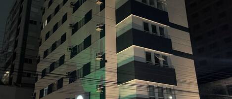 A multi-story hotel with a modern design, featuring a prominent 'HOTEL' sign on the facade.