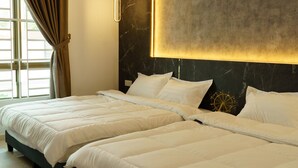 Moderni hotellihuone, jossa on kaksi sänkyä, suuri ikkuna verhoilla ja marmorilla koristeltu seinä.