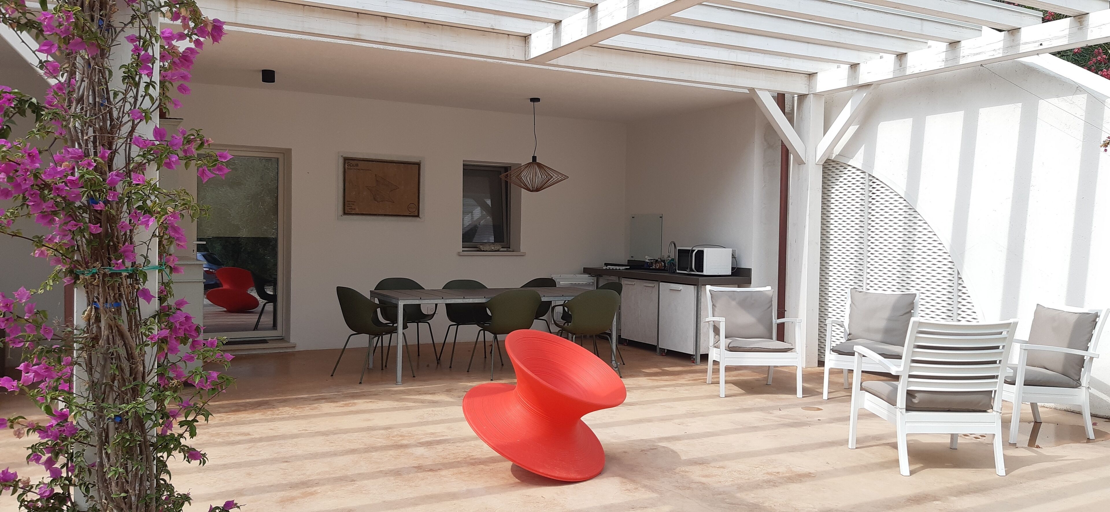 A modern interior with a dining area, kitchen, and seating arrangements.