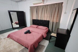 A bedroom with a bed, a mirror, a dresser, and a curtain.