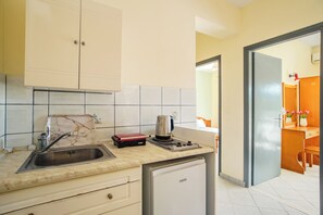 A kitchen with a sink, a coffee maker, a toaster, and a refrigerator. - Solena Studios Kavos (Corfu)