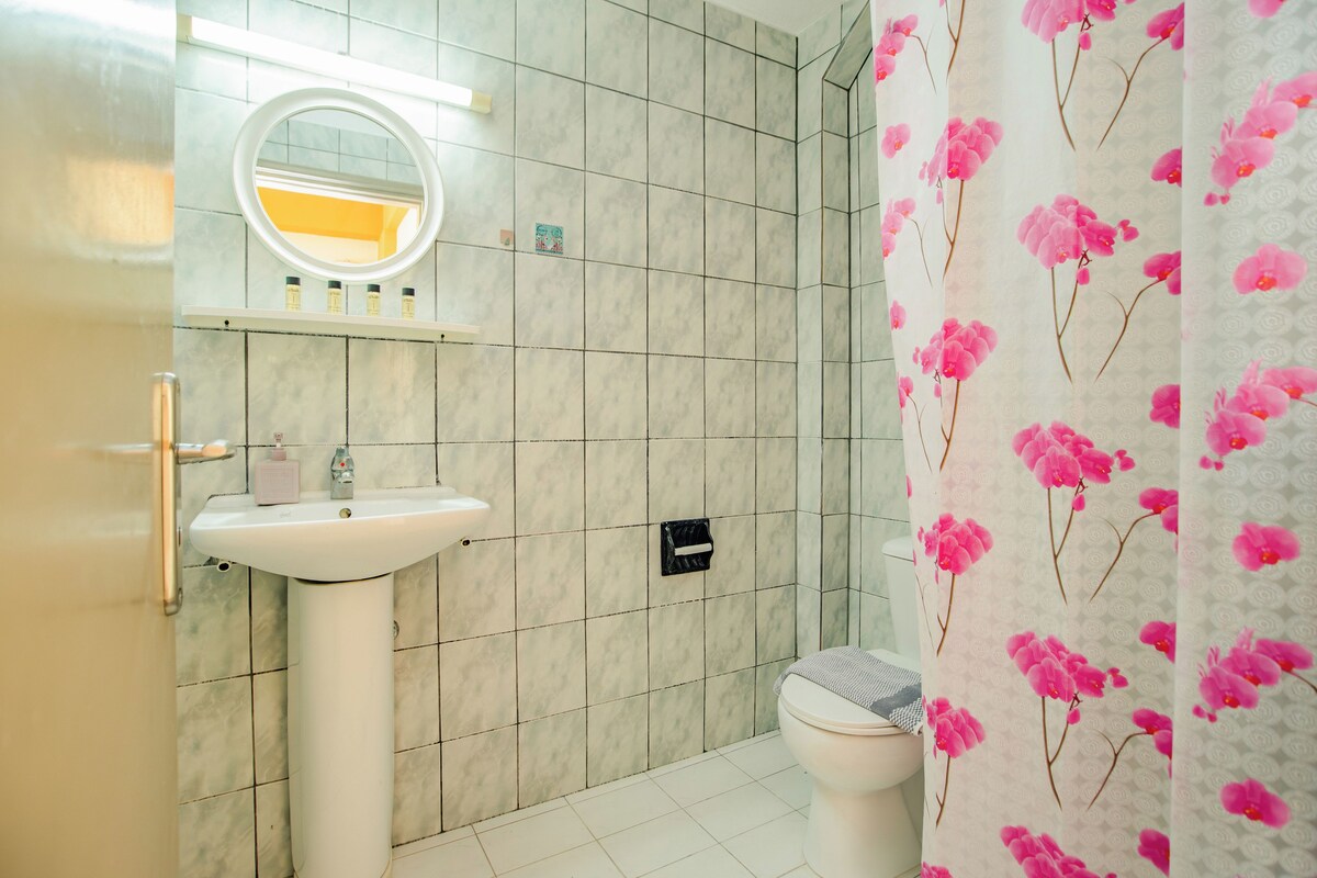 A bathroom with a sink, mirror, and toilet.