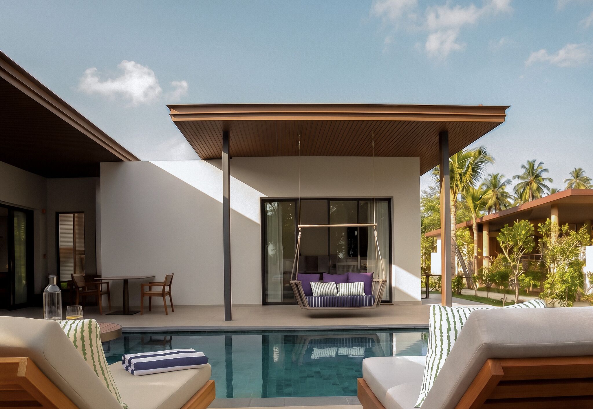 A modern outdoor pool area with a hanging chair, lounge chairs, and a glass-enclosed patio.