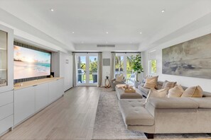 A modern living space with a kitchen, dining area, and seating area. - Modern Luxury in Tropical Paradise at Bahia Beach Resort within the Four Seasons (Río Grande)