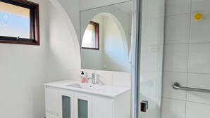 A bathroom with a white vanity, a glass shower enclosure, and a large mirror. - 5 BR House - Private Home on Shared Block (Frankston)