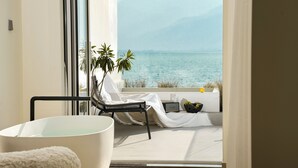 A balcony with a view of the sea, a white chair, a black chair, and a plant. - Three types of cloud river snow shops (Dali)
