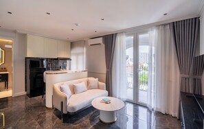 Suite, Balcony | Living area | 50-cm flat-screen TV with satellite channels - AMANA Boutique Hotel - Than Van Nhiep (An Phu)