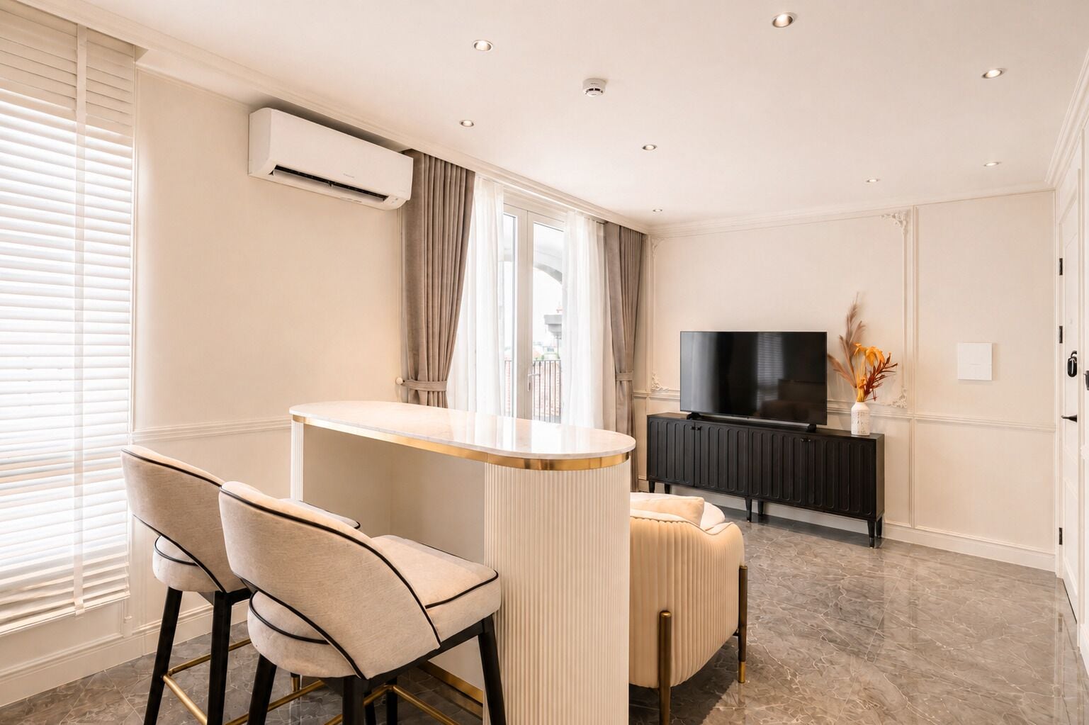 A modern living room with a bar area, a flat-screen TV, and a radiator.