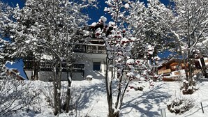 A snow-covered building with a balcony, surrounded by trees and shrubs. - Haus Rupicapra by Interhome (Arosa)