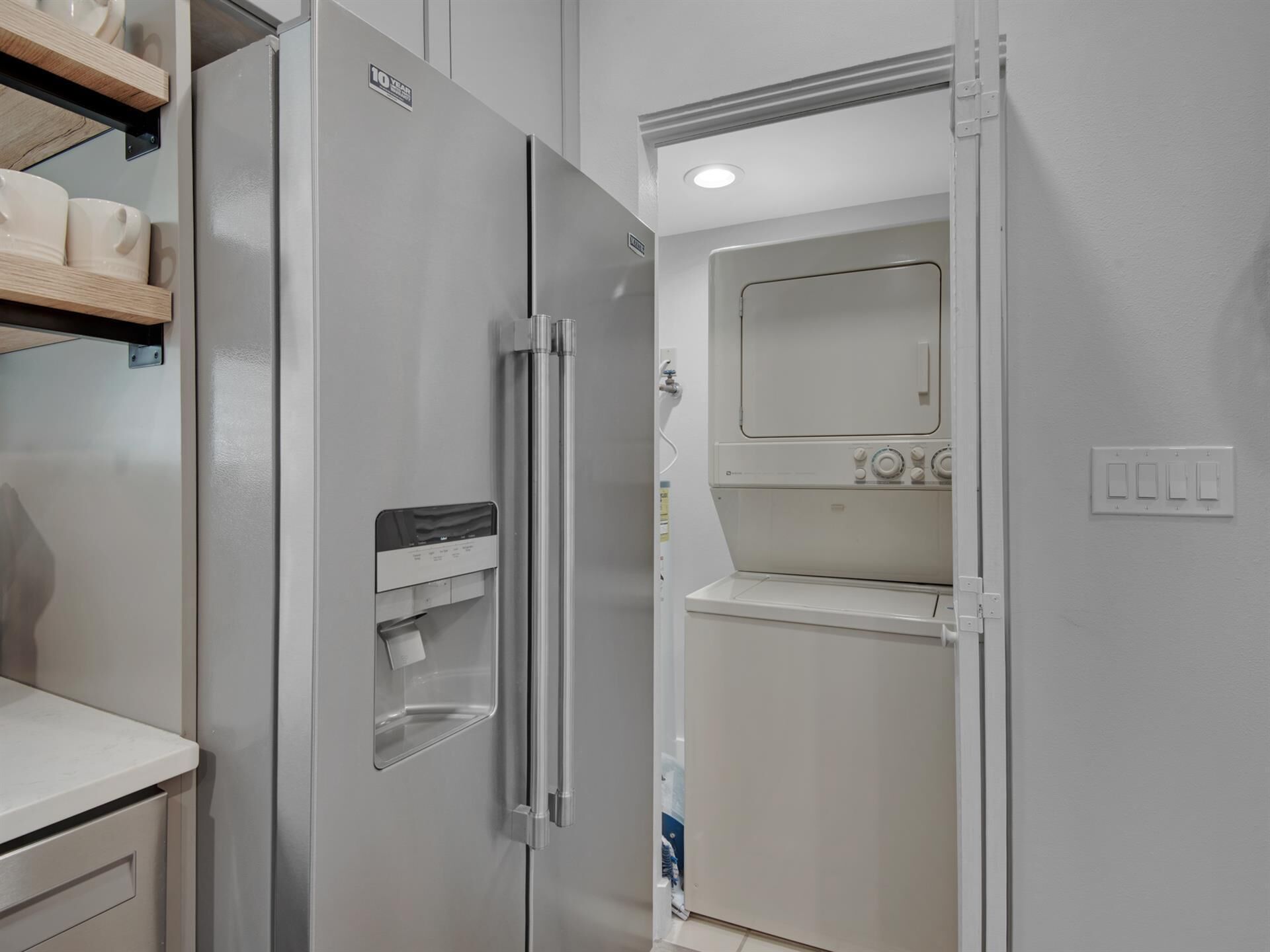 A compact kitchen with a built-in refrigerator and microwave, a small countertop, and a wall-mounted oven.