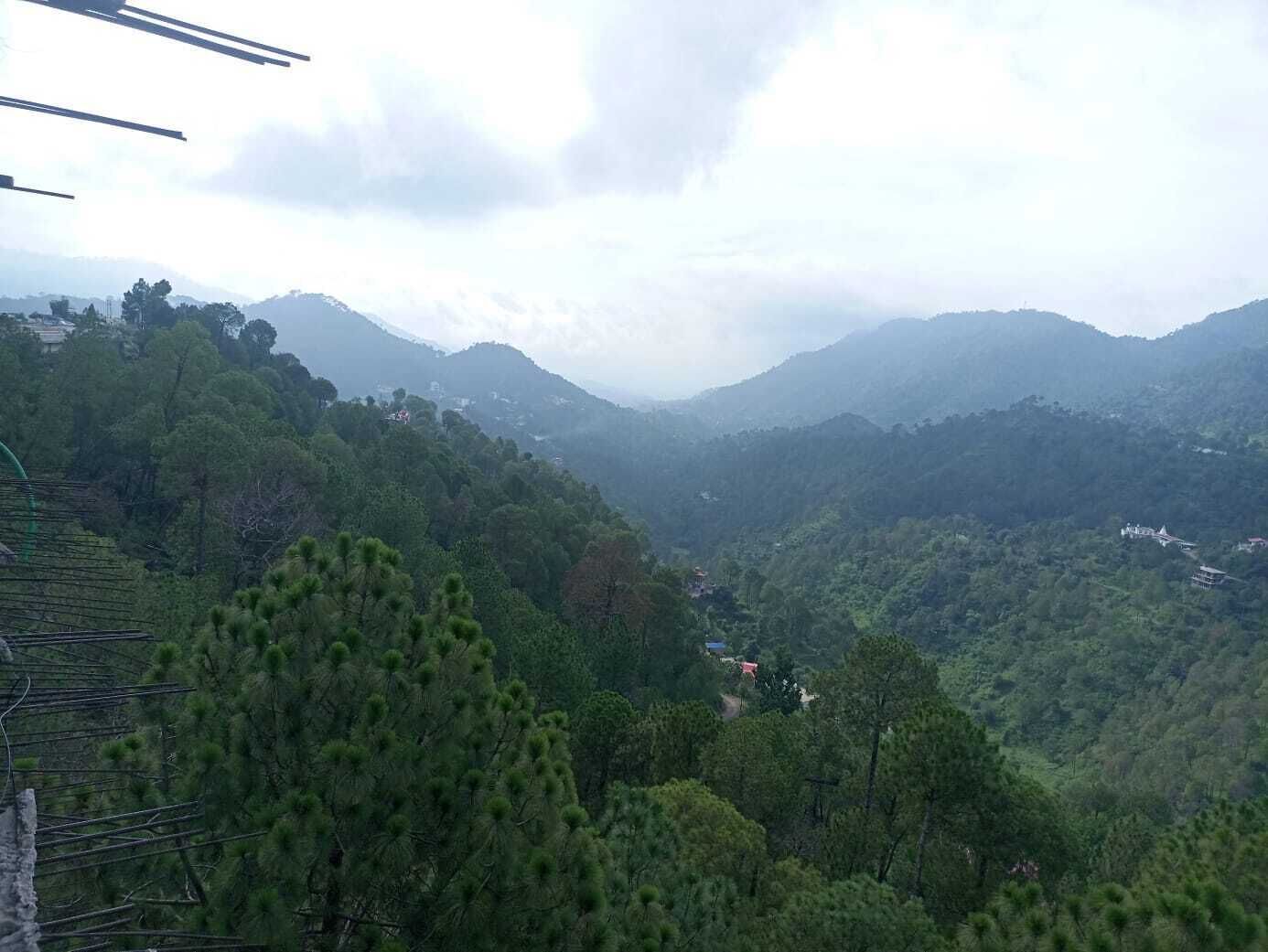 A mountainous landscape with dense forests and scattered buildings.