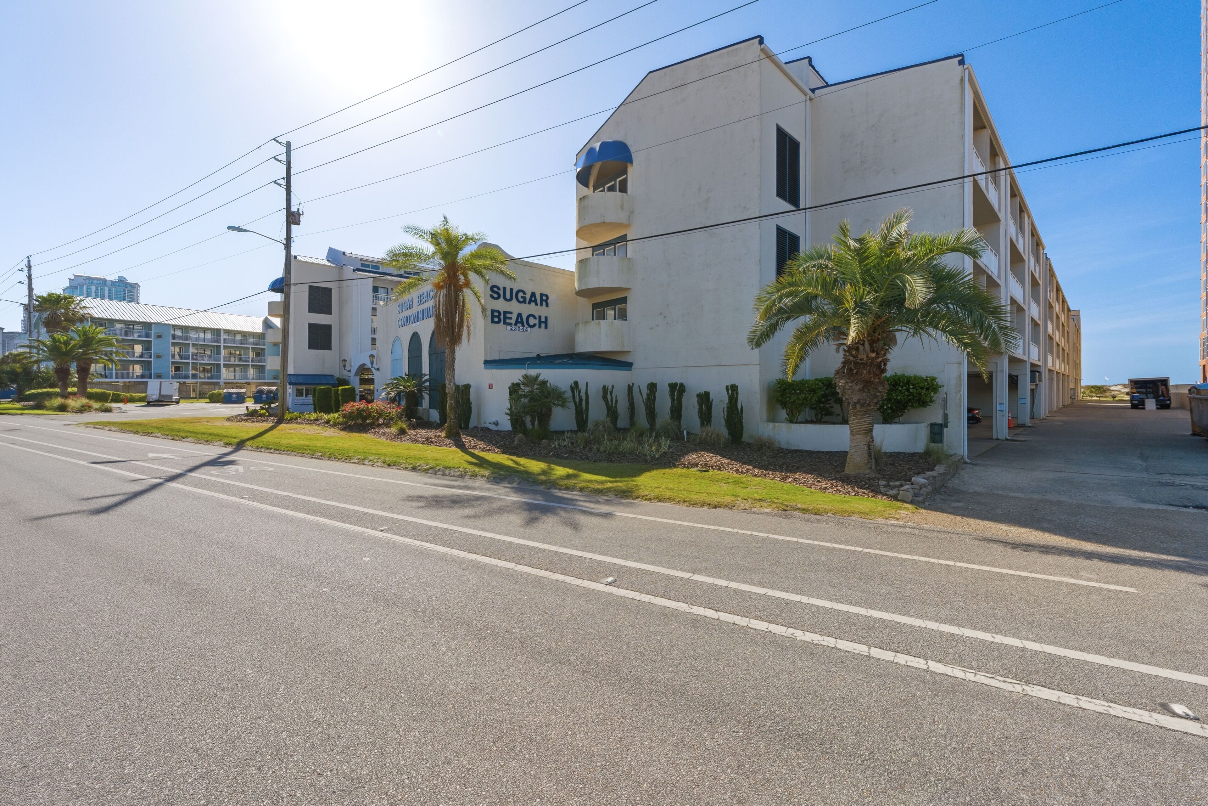 A building with a sign reading 'Sugar Beach' and a road in front.