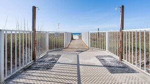 A boardwalk leading to the beach with a 'NO DOGS ALLOWED ON BEACH' sign. - Sugar Beach 313 (Orange Beach)