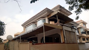 A multi-story residential building with a balcony, a covered porch, and a gated entrance. - Sapphire Lodge (Islamabad)