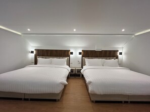 A hotel room with two beds, wooden flooring, and modern lighting fixtures. - Khao Lak - Loft Suite With 2 King Size Beds, Bathroom With Bathtub (Takua Pa)