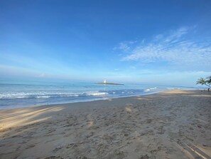 A beach with a lighthouse in the distance, sandy shore, and clear sky. - Khao Lak - Loft Suite With 2 King Size Beds, Bathroom With Bathtub (Takua Pa)