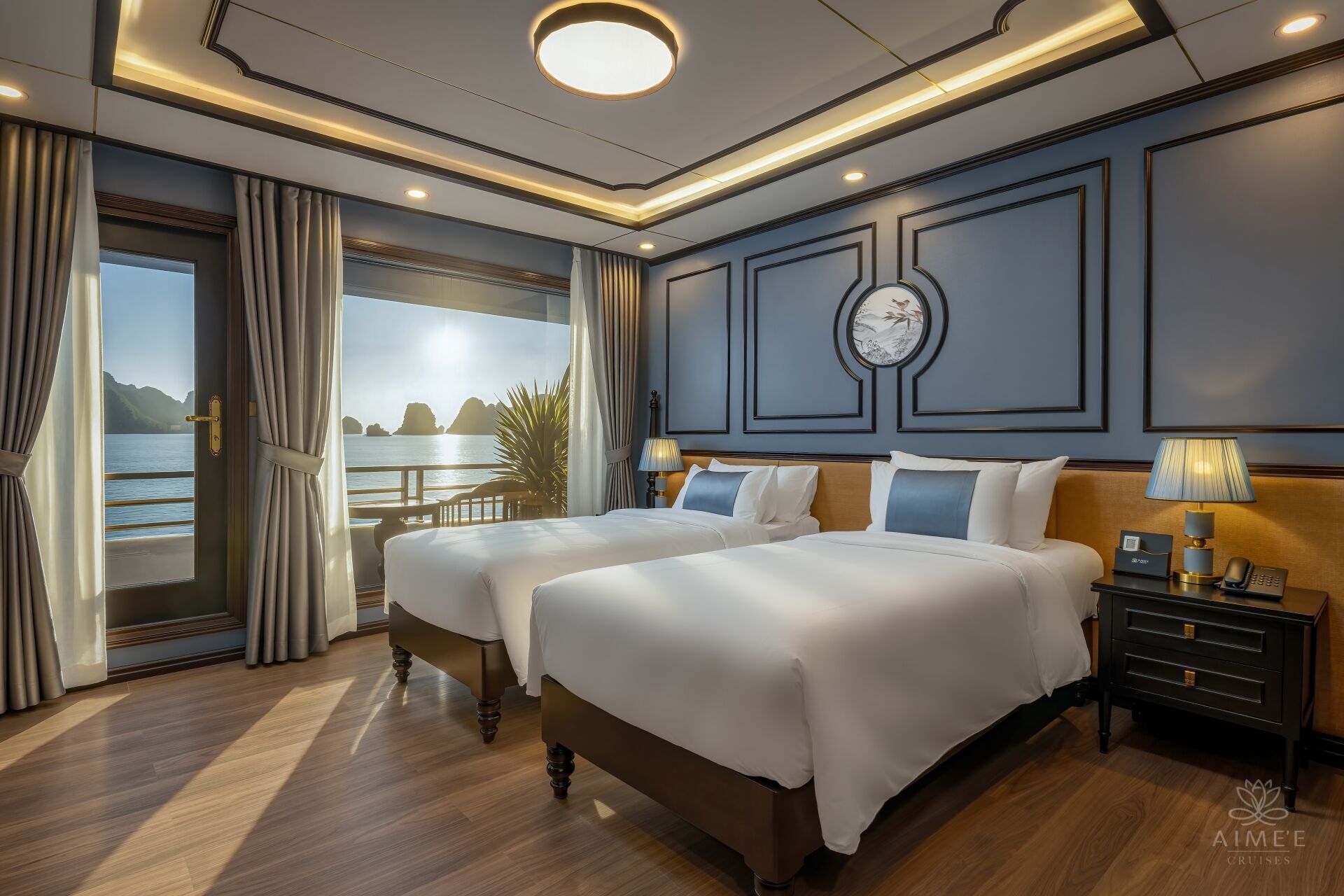 A hotel room with two beds, a view of the sea, and a modern design.
