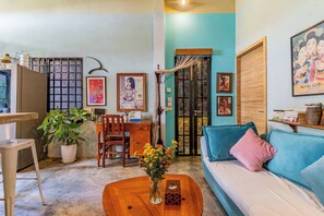 TV, books - Sarai Room a Cozy Urban Hideaway with Green Balcony (Phnom Penh)