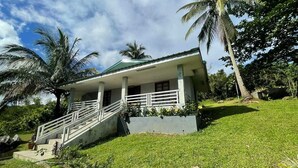 A two-story building with a green roof, white exterior walls, and a covered porch with white railings. - 1193 Pinehall Farm Rizal (Antipolo)