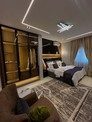 In-room safe, desk, laptop workspace, blackout curtains - Rainno Apartment  (Abuja)