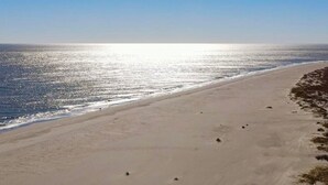 A beach with a clear sky and calm sea. - Newly Renovated First-Floor End-Unit Condo/Ocean Views/Beach Access/Free Parking (Isle of Palms)