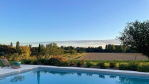 A swimming pool with a view of a field and trees. - Holiday home in Pardaillan with private pool (Pardaillan)