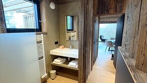 A modern bathroom with a wooden interior, a white sink, and a mirror. - Holiday Home in Malmédy with private terrace (Malmédy)