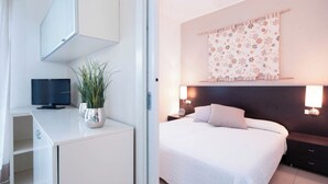 Un dormitorio moderno con cama, mesitas de noche, televisor y una planta en maceta.