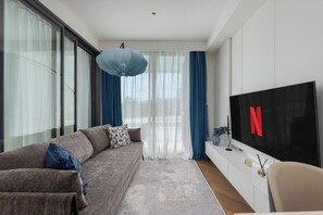 Exclusive Apartment, Pool View | Living area | TV - Kora Beachfront Suite by TropicLook (Choeng Thale)