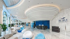 A modern lobby with a reception desk, seating area, and a blue accent wall.