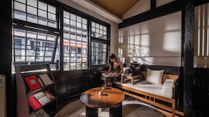A modern living room with a sofa, a coffee table, and a bookshelf.