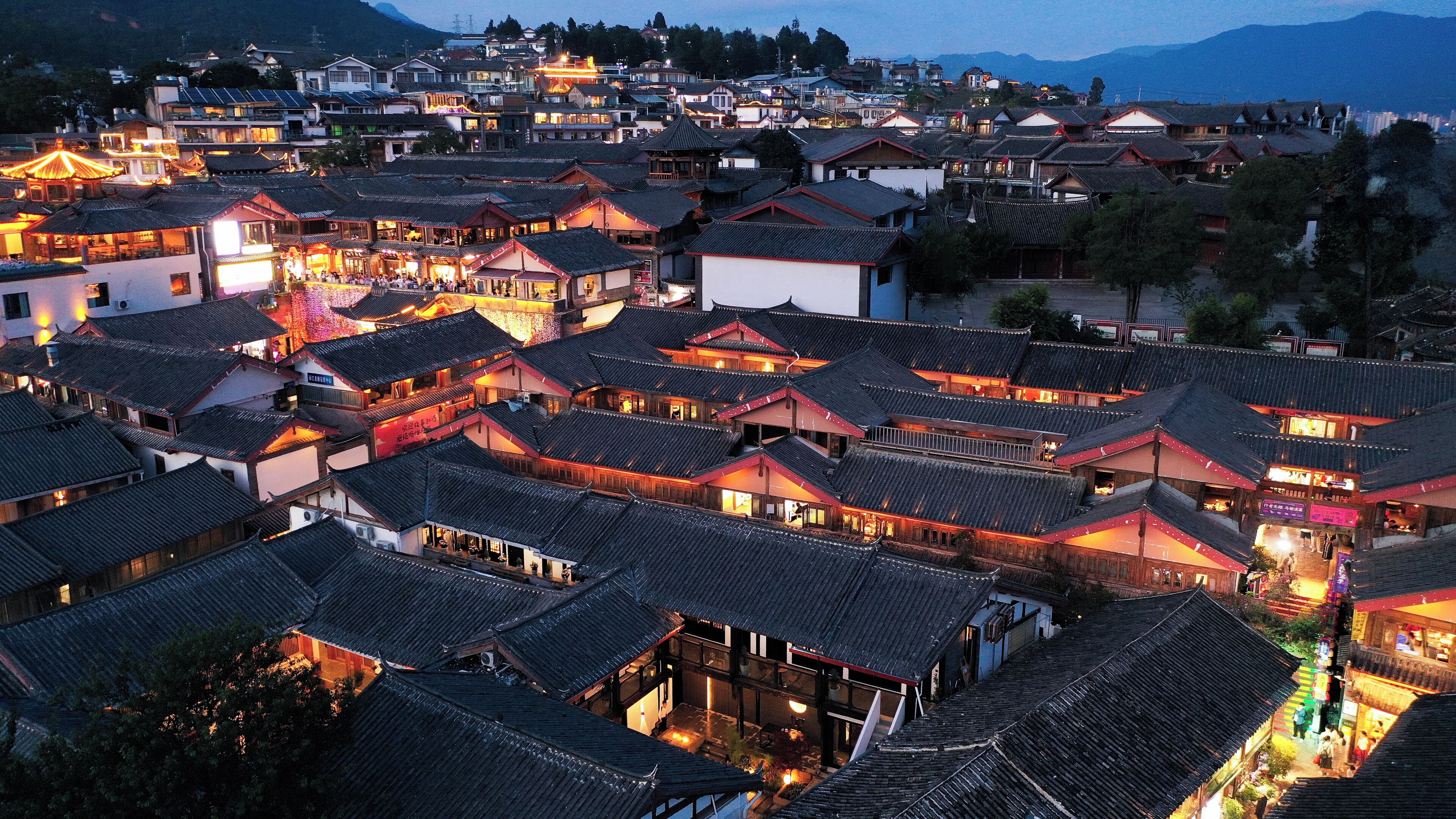 A traditional village with closely packed buildings featuring steeply pitched roofs and wooden structures.