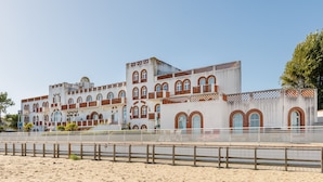 A large, multi-story building with arched windows and a mix of brick and white facade. - Nice Apt 5 pers near the beach with pool (La Tranche-sur-Mer)