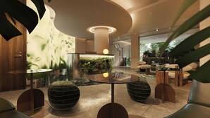 A modern lobby with a central seating area, a decorative wall with a green accent, and a reception desk. - KiN Hotel Central Park (Ho Chi Minh City)