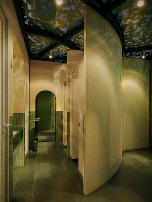 A modern interior with a curved wall, a green door, and a tiled floor. - KiN Hotel Central Park (Ho Chi Minh City)