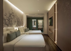 A hotel room with two beds, a large wall art, a mirror, a wardrobe, and a TV. - KiN Hotel Central Park (Ho Chi Minh City)
