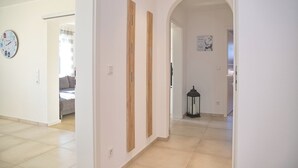 A hallway with a clock, wooden panels, and a lantern. - Top modern vacation apartment 90 m² in a central location in Grömitz. (Grömitz)