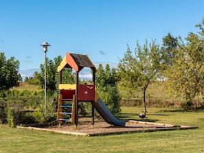 Une aire de jeux avec un toboggan et une structure dâescalade.