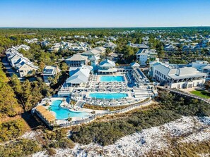 An aerial view of a resort with a large pool, multiple buildings, and surrounding greenery. - 🦩Book Me Baby! Beach Cruiser Cottage in WaterColor Golf Cart & Bikes🦩 (Santa Rosa Beach)