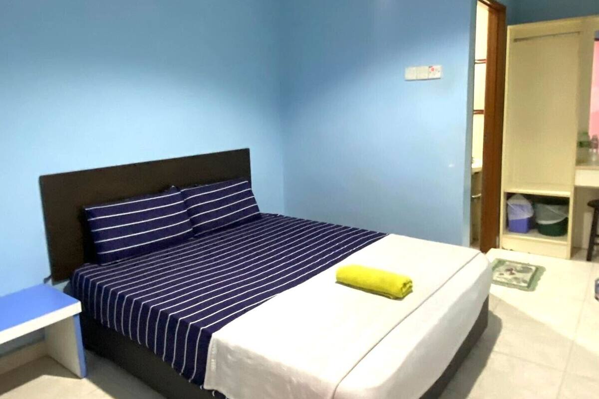 Un dormitorio con cama, escritorio y armario.