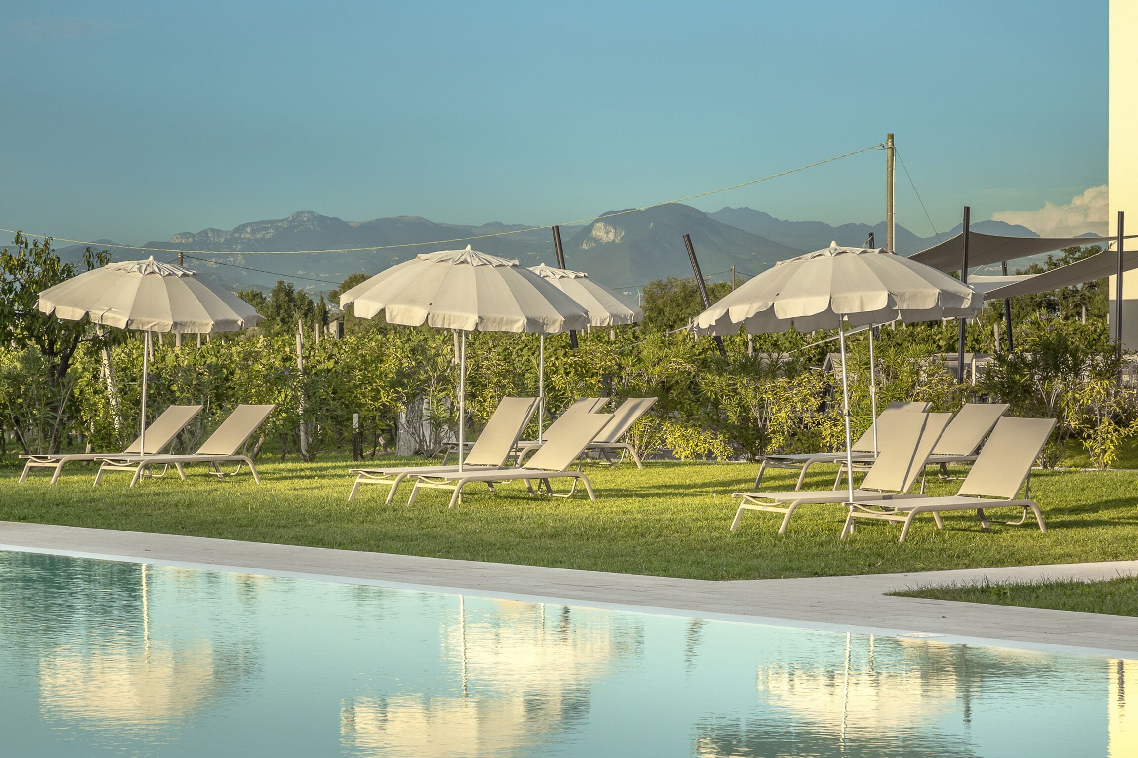 Seasonal outdoor pool, open 9:00 AM to 7:30 PM, pool umbrellas