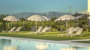 Seasonal outdoor pool, open 9:00 AM to 7:30 PM, pool umbrellas