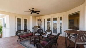 A covered patio area with wicker furniture, a ceiling fan, and a barbecue grill. - Las Palmas Resort #808 | All-Inclusive Amenities (Saint George)