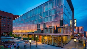 A modern glass building with a flat roof and a large entrance area. - In The Heart of Boston’s Seaport + Rooftop Bar (Boston)