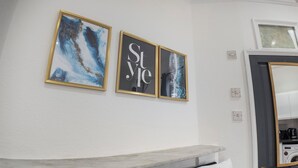 A bathroom with a white wall, a marble countertop, and a washing machine. - Spacious Charming Studio in Birmingham (Birmingham)
