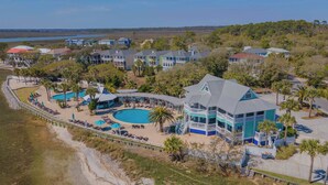 A resort with multiple swimming pools, a beach area, and a large building with balconies. - 798 Marlin Drive (Saint Helena Island)